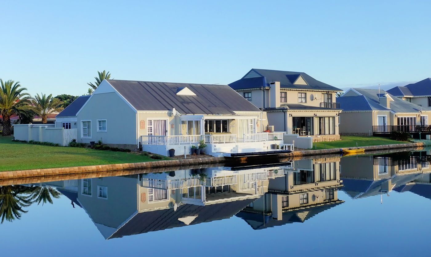 Waterfront homes reflected in still water