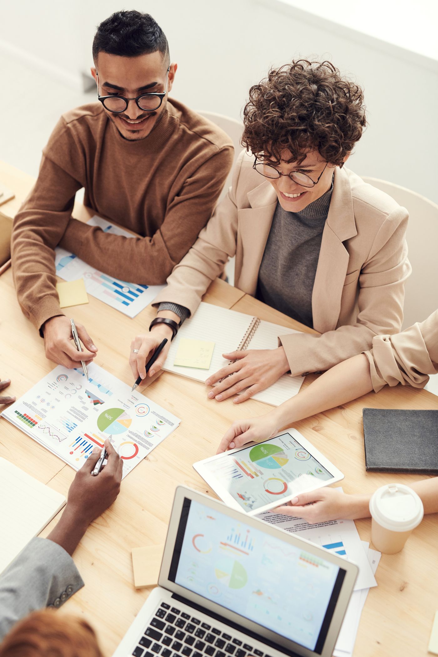 Professionals reviewing printed charts at a table