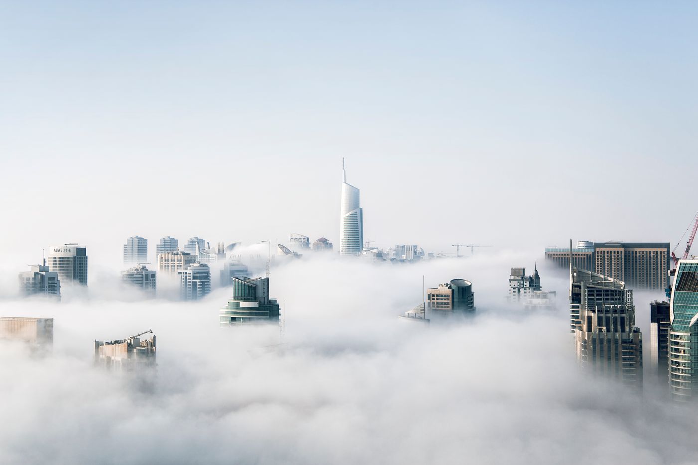 City towers emerging above a layer of cloud
