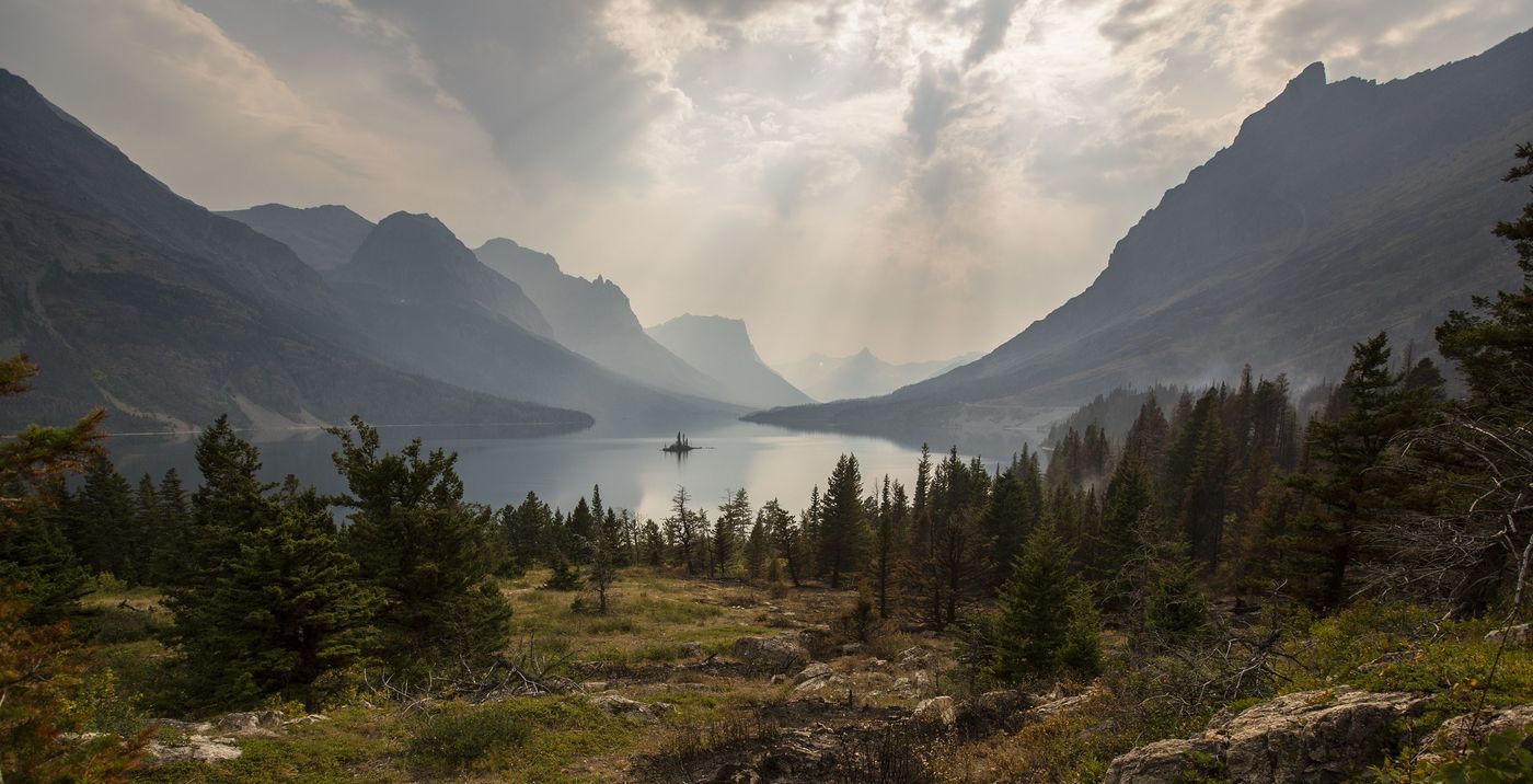 A broad mountain valley beneath a cloudy sky